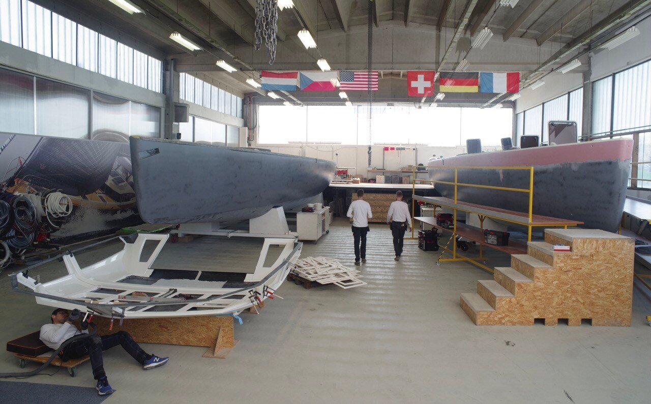 Pegasus crew working on hull and deck joint. The deck is glued and laminated to the hull.